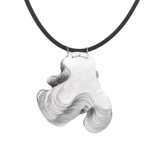 A laser cut stacked paper pendant in gray, with a silicone neck cord and a sterling clasp.