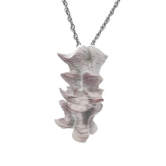 A laser-cut Tyvek paper pendant with a neutral pink shade, designed to resemble a hoodoo or sea stack, attached to a stainless steel neck cord.