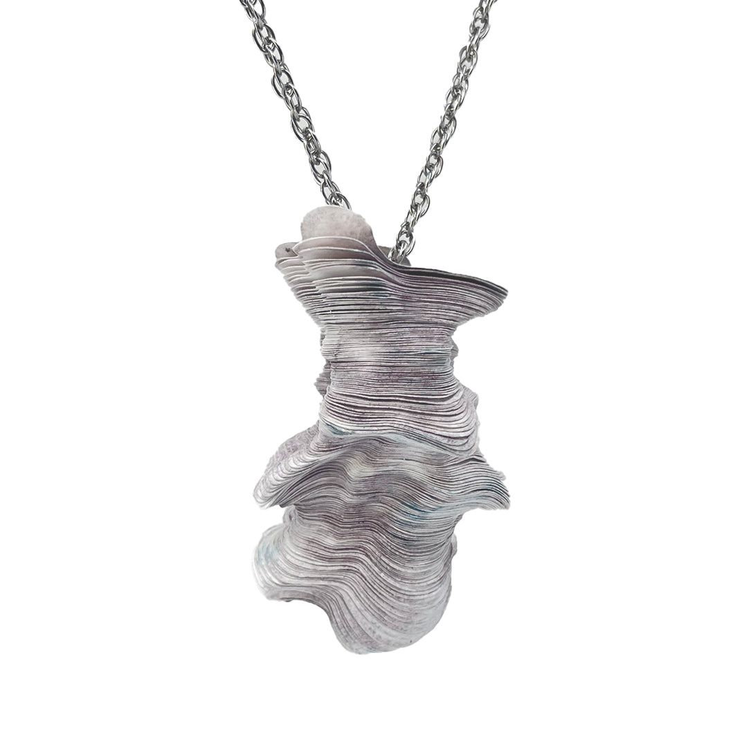 A laser-cut Tyvek paper pendant with a stainless steel neck cord, featuring shades of purple and blue.