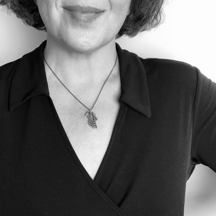 Black and White Image of Necklace on Model for Scale