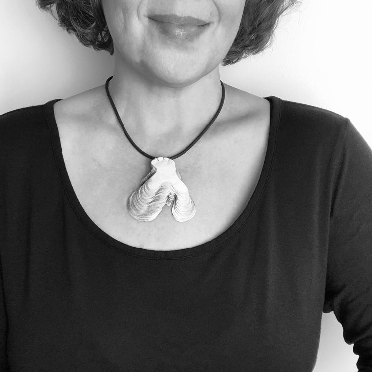 Black and White Image of Necklace on Model for Scale