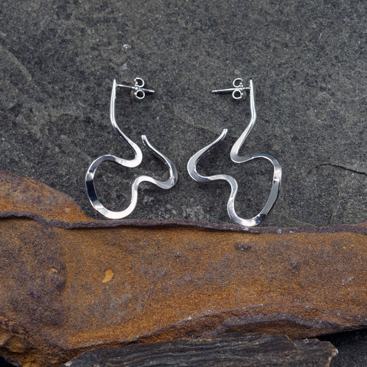 Modern sterling silver wave earrings with abstract sculptural design