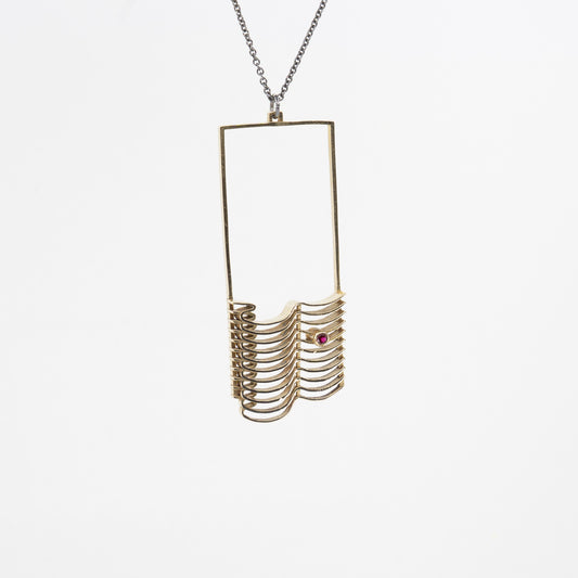 A CAD and cast brass pendant with a chain necklace, featuring a faceted round simulated garnet stone.